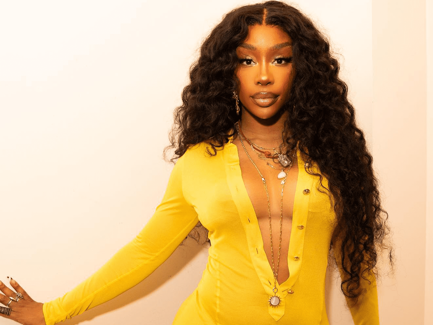 Sza in a yellow dress