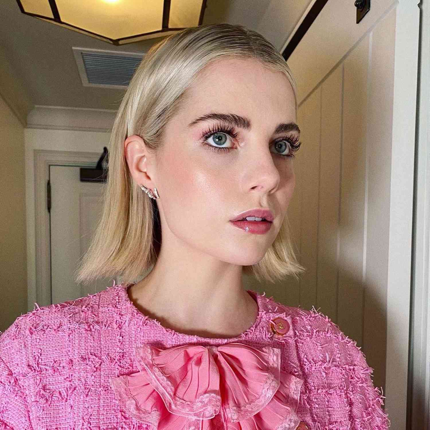 Lucy Boynton wears a slicked-down bob