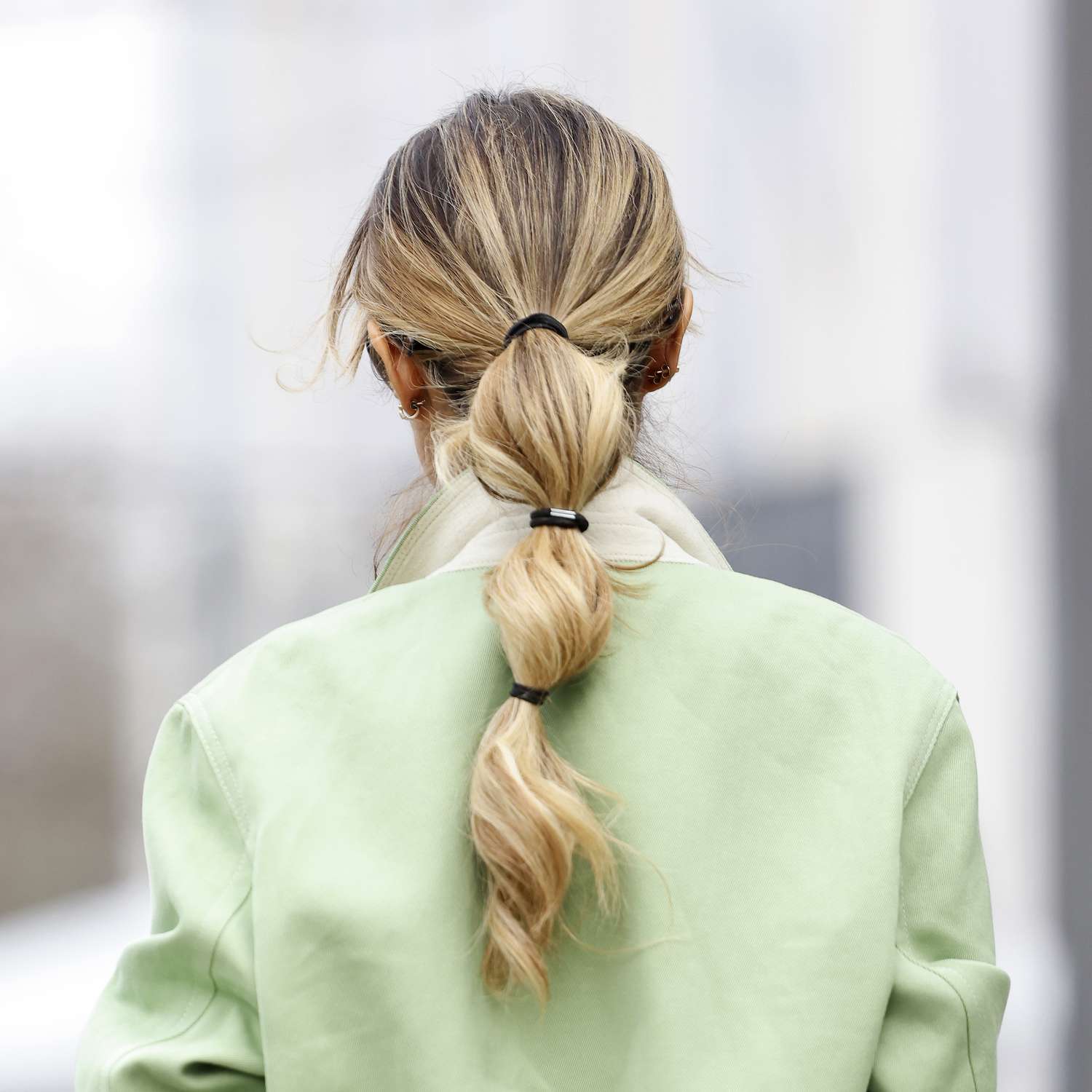 back of woman with blonde hair in low bubble ponytail