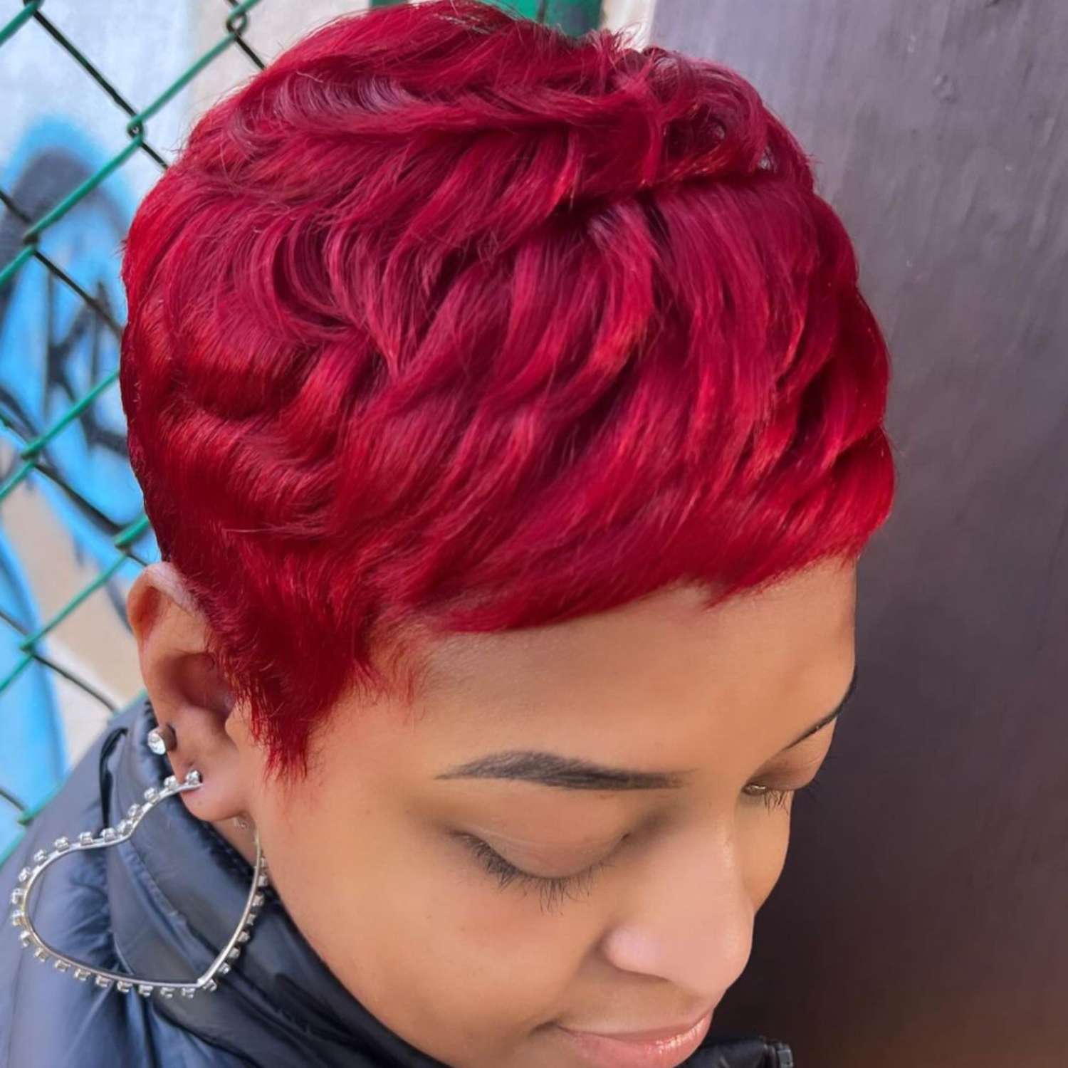 Crimson-colored pixie cut.