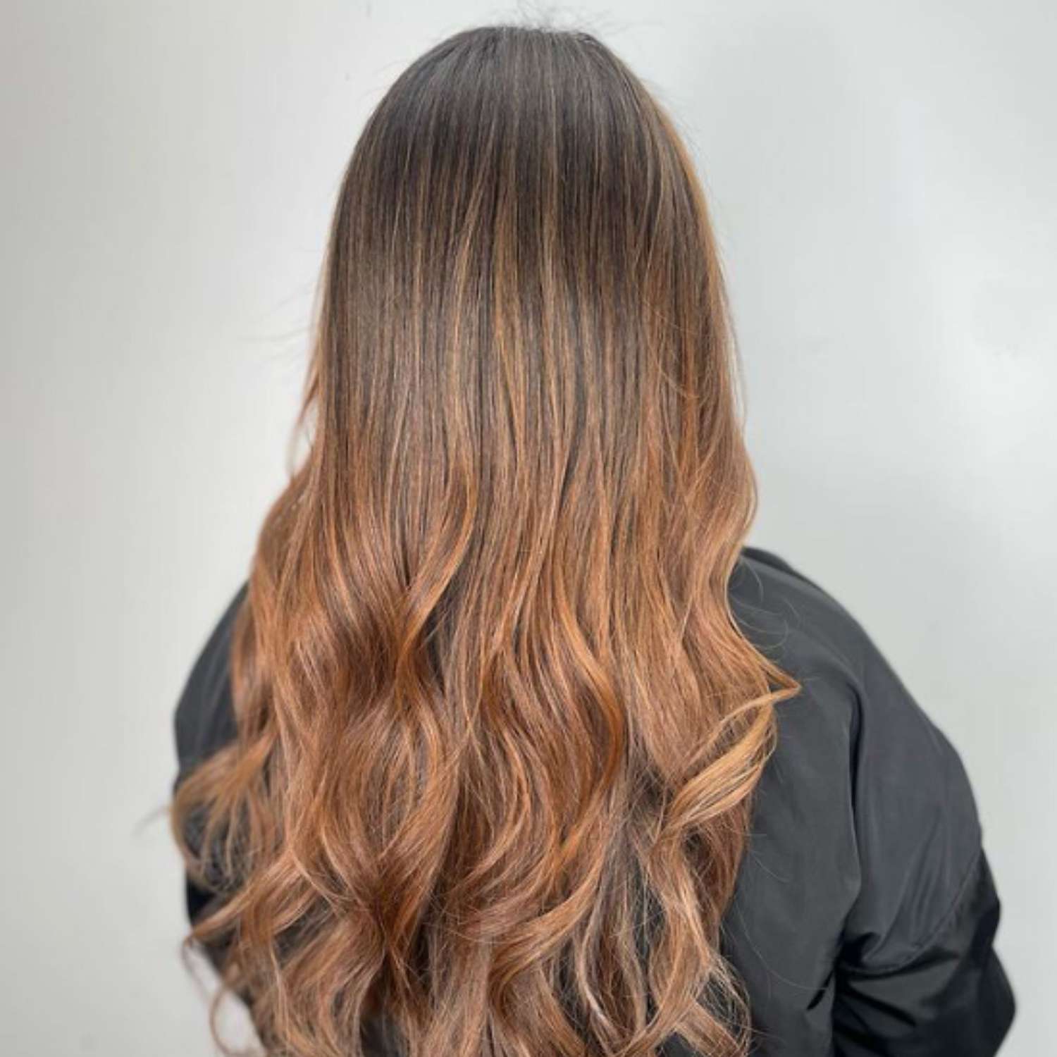 Long hair with auburn highlights weaved throughout.