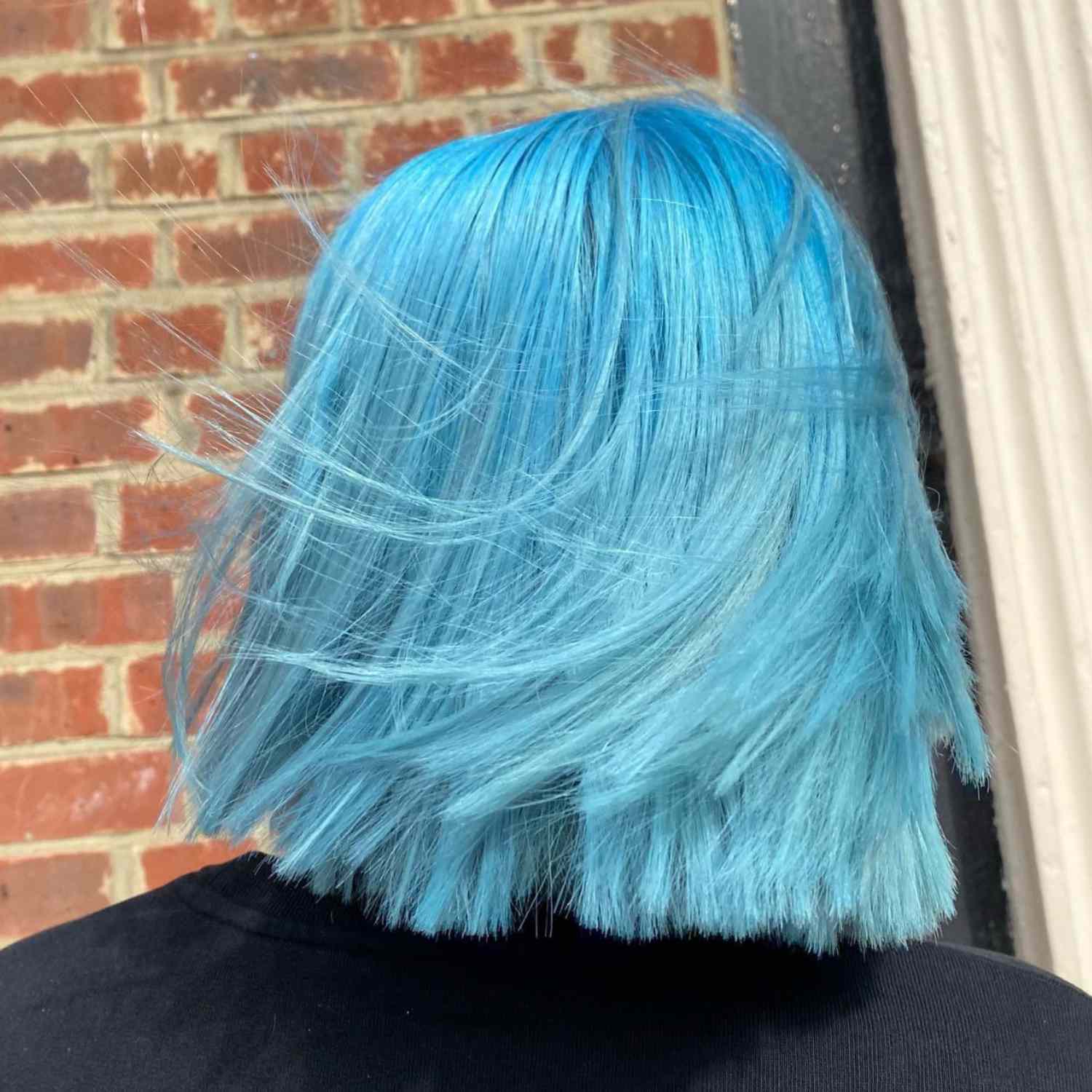 A blunt-cut, baby blue bob viewed from behind