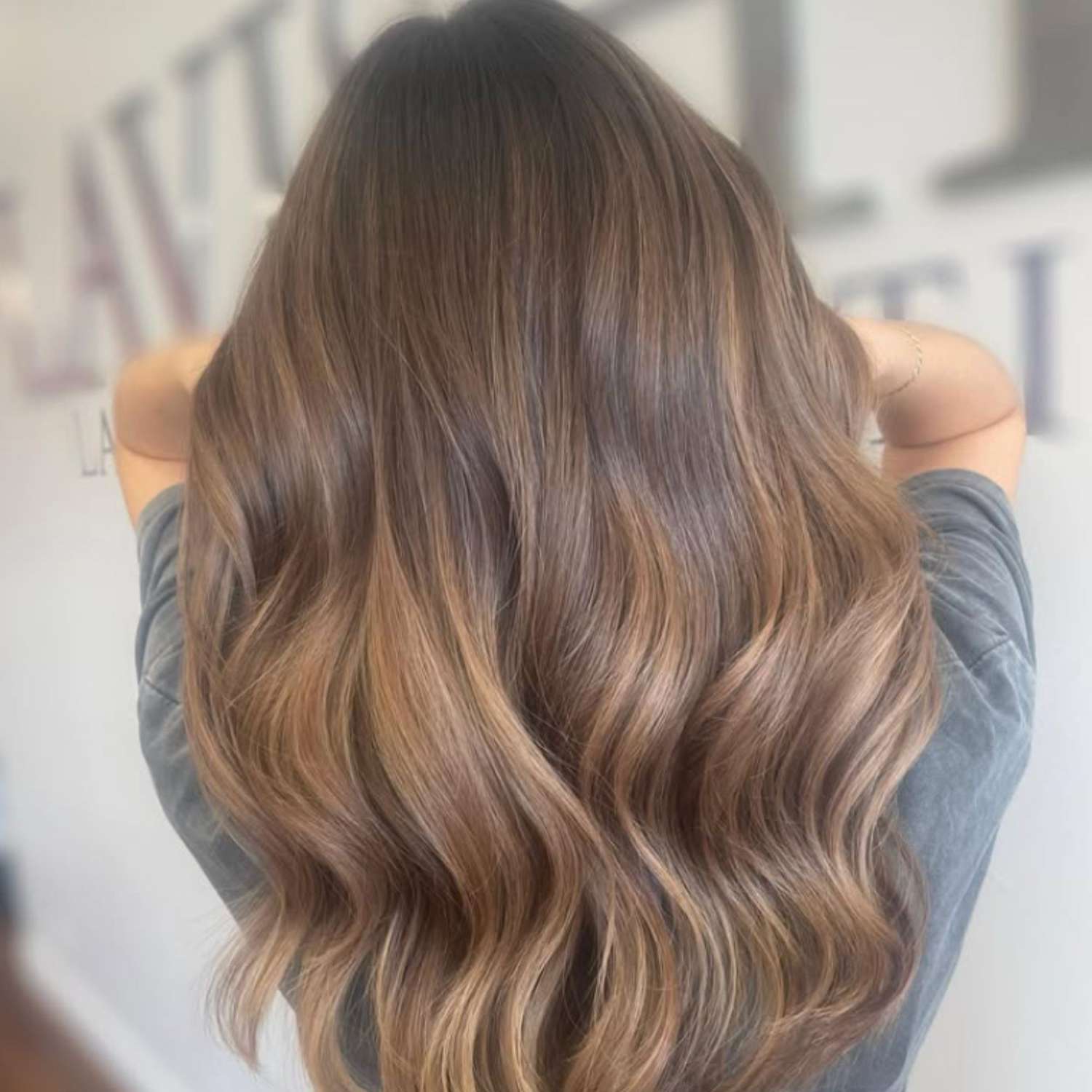 Long wavy brown hair with caramel balayage.