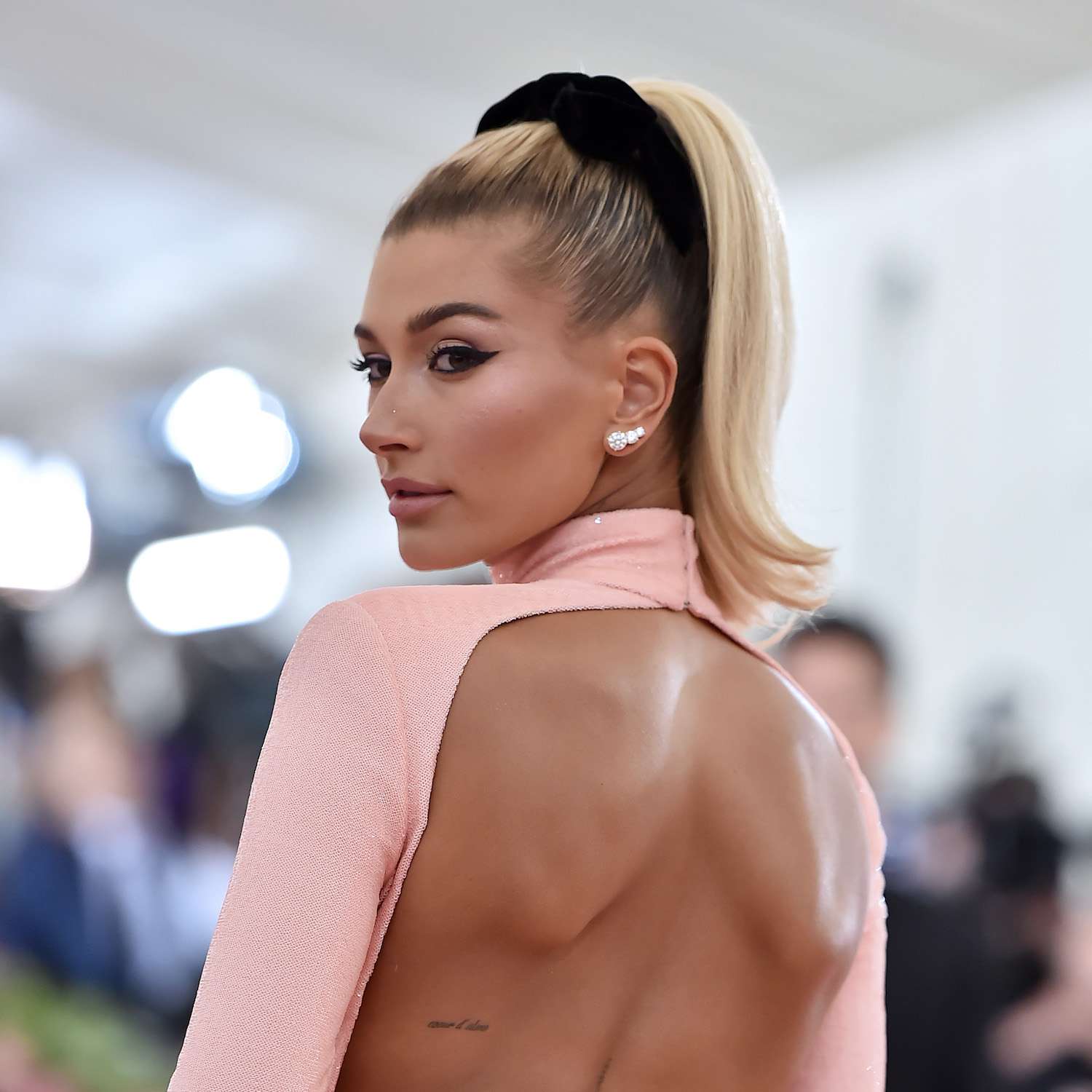 Hailey Bieber with a high ponytail with a wrapped in a velvet ribbon