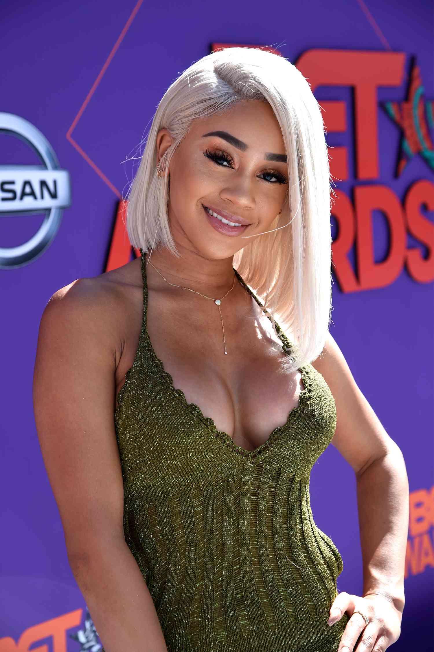 Rapper Saweetie with a blonde lob with a deep side part