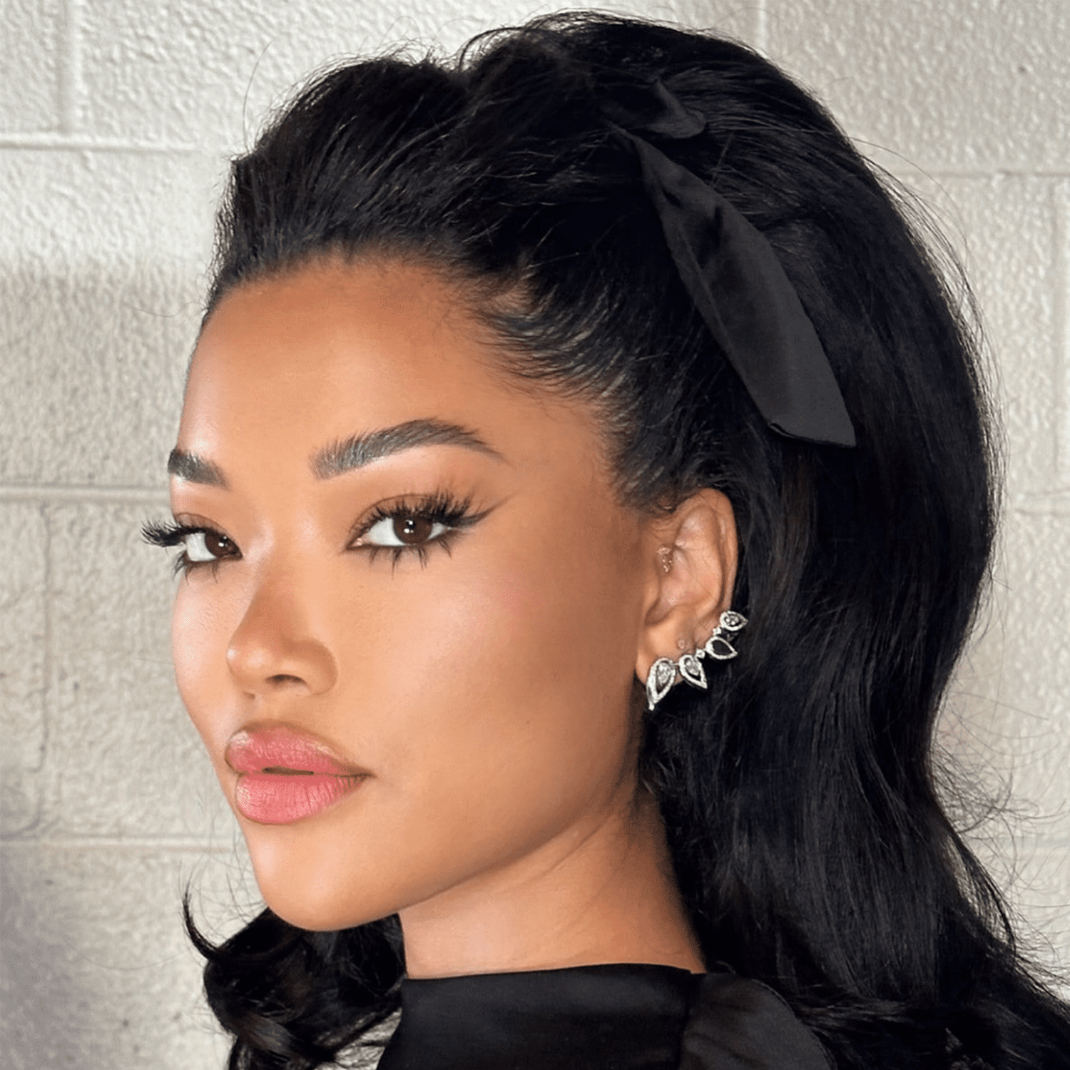 Ming Lee Simmons wearing voluminous blowout with black ribbon